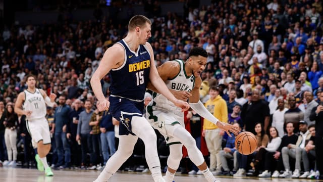 Milwaukee Bucks forward Giannis Antetokounmpo (34) drives to the basket against Denver Nuggets center Nikola Jokic (15) 